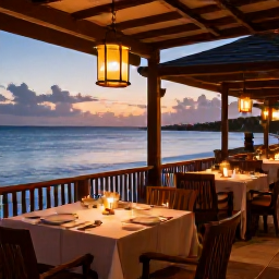 Caribbean Holidays, Barbados Luxury Holidays, A refined outdoor restaurant in Barbados at sunset, serving Caribbean cuisine beside the sea with warm lantern light