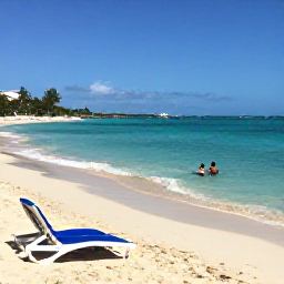 Caribbean Holidays, Barbados October Breaks, Barbados beach near Bridgetown in October with turquoise water, pale sand, sun loungers and a couple enjoying a peaceful swim