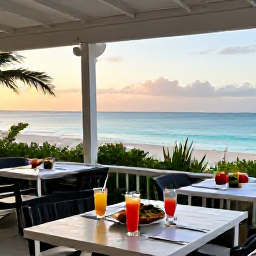 Caribbean Holidays, Bermuda Beach Holidays, An outdoor restaurant overlooking the Bermuda coastline at sunset, with fresh seafood, colourful drinks and a relaxed dining scene