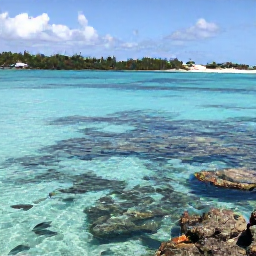 Caribbean Holidays, Bermuda Beach Holidays, Visitors snorkelling in clear Bermuda water near a rocky reef, tropical fish visible beneath the surface
