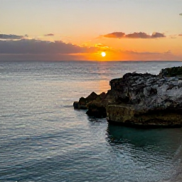 Caribbean Holidays, Bermuda Instagram Hotspots, A peaceful Bermuda coastline with clear water, rugged rocks and a vivid sunset over the Atlantic Ocean