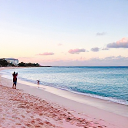 Caribbean Holidays, Bermuda Instagram Spots, A bright winter morning at Horseshoe Bay Beach in Bermuda, with pink sand, turquoise water and a few visitors taking photographs