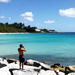 Caribbean Holidays, Bermuda Instagram Spots, Quiet Bermuda coastline in October with clear turquoise water, rocky shoreline and a person photographing the view
