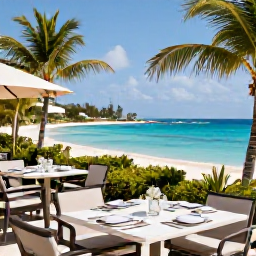 Caribbean Holidays, Bermuda Luxury Holidays, Elegant luxury resort overlooking a bright turquoise Bermudian bay in July, with palm trees, white sand and a refined outdoor dining terrace