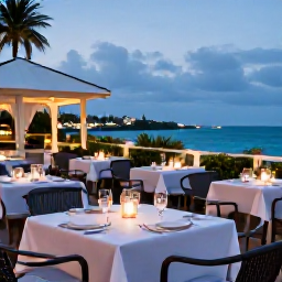 Caribbean Holidays, Bermuda Luxury Holidays, Elegant outdoor restaurant in Hamilton Bermuda at dusk, local seafood, smart tables and soft lights