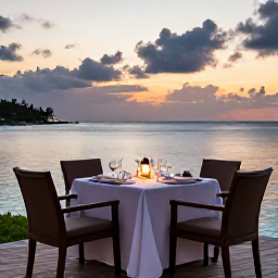 Caribbean Holidays, Bermuda Luxury Holidays, Romantic Bermuda waterfront restaurant at sunset, with an elegantly set table, calm sea and pastel evening sky