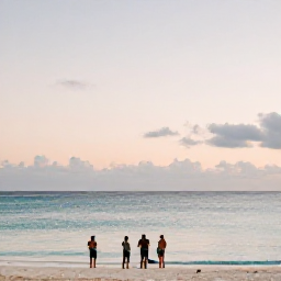 Caribbean Holidays, Bermuda Nature Holidays, A relaxed evening on a Bermuda beach with calm sea, pastel sunset light and visitors watching the changing sky
