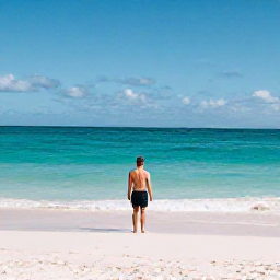 Caribbean Holidays, Bermuda Solo Holidays, A solo traveller enjoying a quiet pink-sand beach in Bermuda beneath a bright November sky
