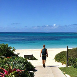 Caribbean Holidays, Bermuda Walking Holidays, A peaceful Bermuda beach and coastal path in April, with a walker looking across clear blue water
