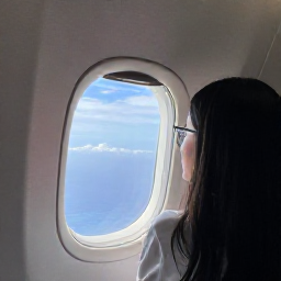 Caribbean Holidays, British Virgin Islands Business Class, Luxury business-class aircraft cabin with a traveller looking out towards bright Caribbean skies
