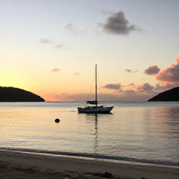 Caribbean Holidays, British Virgin Islands June, A small sailing boat anchored in a calm bay near a quiet British Virgin Islands beach at sunset