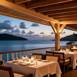 Caribbean Holidays, BVI Adults Only July, Elegant open-air restaurant at an adults-only Caribbean resort in the British Virgin Islands, serving dinner beside the sea at dusk