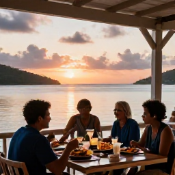 Caribbean Holidays, BVI Beach Holidays, A friendly beachfront restaurant in the British Virgin Islands at sunset, with diners enjoying fresh seafood, rum drinks and views across a calm bay