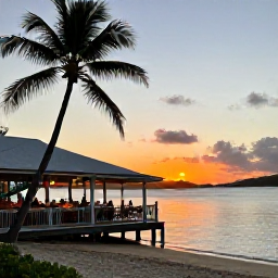 Caribbean Holidays, BVI November Holidays, Peaceful British Virgin Islands sunset over a palm-fringed beach, with a small waterfront restaurant and guests enjoying an evening meal