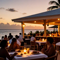 Caribbean Holidays, Caribbean Multi-Centre, Travellers relaxing at an open-air Caribbean restaurant at sunset, with local food, soft lights and a welcoming island atmosphere