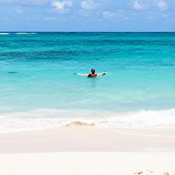 Caribbean Holidays, Caribbean Swimming, A swimmer floating in clear turquoise Caribbean sea beside a quiet white-sand beach, bright tropical daylight