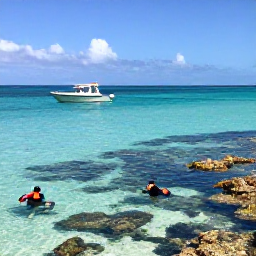 Caribbean Holidays, Cayman Adventure, Clear turquoise sea, a small boat and snorkellers exploring coral reefs off Grand Cayman in bright February sunshine