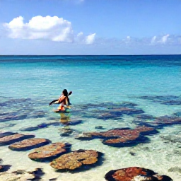 Caribbean Holidays, Cayman Adventure Holidays, Clear turquoise water, colourful coral reef and a snorkeller exploring the calm sea around Grand Cayman in bright April sunshine