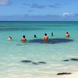 Caribbean Holidays, Cayman Beach Holidays, People swimming and snorkelling in clear shallow water beside a calm Cayman Islands beach, colourful fish visible near the reef
