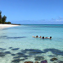 Caribbean Holidays, Cayman Beach Holidays, Visitors swimming and snorkelling in clear shallow water beside a quiet Cayman Islands beach, with colourful fish visible near coral and bright summer sunlight