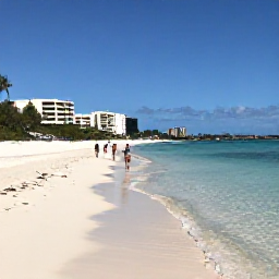 Caribbean Holidays, Cayman Beach Holidays, Visitors walking along the calm shoreline of Seven Mile Beach, with clear shallow water, white sand and low-rise resorts in the background