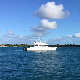 Caribbean Holidays, Cayman Diving September, A dive boat travelling across calm blue Caribbean water near Grand Cayman, with a bright sky and low tropical coastline