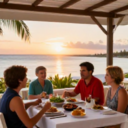 Caribbean Holidays, Cayman Family Holidays, Family enjoying an outdoor Caribbean meal at a relaxed restaurant in Grand Cayman at sunset