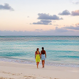 Caribbean Holidays, Cayman Honeymoons, Newlywed couple walking along Seven Mile Beach in Grand Cayman at sunset, calm turquoise sea and soft golden light