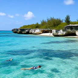 Caribbean Holidays, Cayman Instagram Hotspots, The colourful waters and dramatic limestone shoreline of Smith Barcadere in Grand Cayman, with snorkellers and tropical fish visible in the clear sea