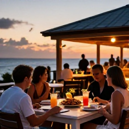 Caribbean Holidays, Cayman Islands October, Outdoor Caribbean restaurant at sunset in Grand Cayman, with fresh seafood, tropical drinks and diners enjoying a relaxed evening