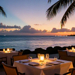 Caribbean Holidays, Cayman Islands Tours, A relaxed Caribbean evening at a Grand Cayman waterfront restaurant, with outdoor tables, local food and a colourful sunset over the sea