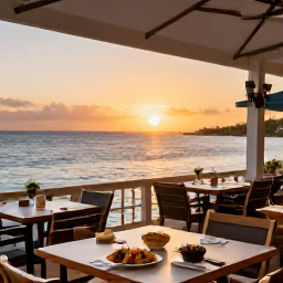 Caribbean Holidays, Cayman Islands Tours, Relaxed waterfront restaurant in Grand Cayman at sunset, with outdoor tables, Caribbean dishes and gentle sea views
