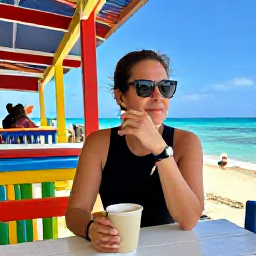 Caribbean Holidays, Cayman Solo Holidays, A friendly solo traveller enjoying a coffee at a colourful waterfront caf&eacute; in George Town, Grand Cayman