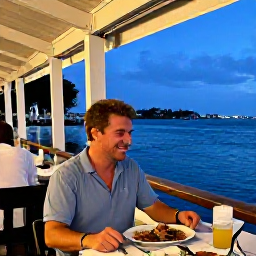 Caribbean Holidays, Cayman Solo November, Friendly solo traveller enjoying a meal at an outdoor waterfront restaurant in George Town, Cayman Islands, evening atmosphere