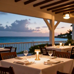 Caribbean Holidays, Cayman Spa Breaks, A relaxed evening restaurant in Grand Cayman serving fresh Caribbean seafood, with warm lighting and a view of the sea
