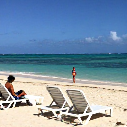 Caribbean Holidays, Cayman Spa Breaks, Quiet Seven Mile Beach scene with sun loungers, clear water and a person walking along the shoreline in April