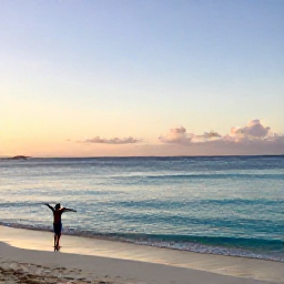 Caribbean Holidays, Cayman Wellness, A peaceful sunrise over Seven Mile Beach in Grand Cayman, with calm turquoise water, soft sand and a person stretching beside the shore