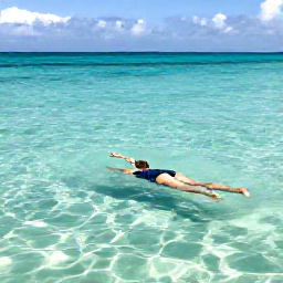 Caribbean Holidays, Cayman Wellness, Traveller swimming slowly in clear Caribbean water near a quiet Grand Cayman beach, with sunlight beneath the surface