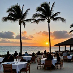Caribbean Holidays, Cheap Aruba December, Aruba sunset over the Caribbean Sea with palm trees, relaxed diners and warm evening light