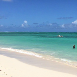 Caribbean Holidays, Cheap Bahamas Holidays, Sunny Nassau beach in The Bahamas during June, with clear turquoise water, white sand and relaxed travellers