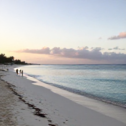 Caribbean Holidays, Cheap Cayman December, Seven Mile Beach in Grand Cayman at sunrise, calm turquoise water, soft white sand and a few relaxed holidaymakers