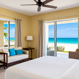 Caribbean Holidays, Cheap Cayman Holidays, Comfortable simple hotel room near the coast in Grand Cayman, with tropical light and practical furnishings