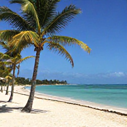 Caribbean Holidays, Cheap Cuba April, Relaxed Cuban beach resort with palm trees, soft white sand and clear blue water under an April sky