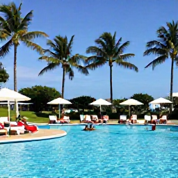 Caribbean Holidays, Cheap Cuba August, Travellers relaxing beside a Cuban resort pool with palm trees and bright summer sunshine