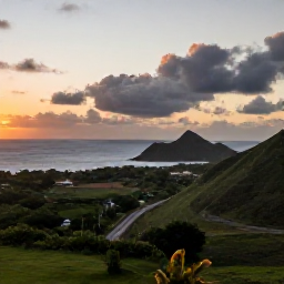 Caribbean Holidays, Cheap Cura&ccedil;ao October, Cura&ccedil;ao countryside at sunset with rugged coastline, low green hills and a small road leading towards the sea