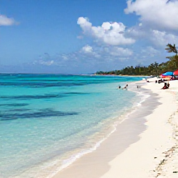 Caribbean Holidays, Cheap December Cura&ccedil;ao, A sunny Cura&ccedil;ao beach in December with clear turquoise water, pale sand, colourful umbrellas and relaxed holidaymakers