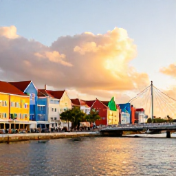 Caribbean Holidays, Cheap December Cura&ccedil;ao, Willemstad waterfront at sunset in Cura&ccedil;ao, showing colourful Dutch Caribbean buildings, the Queen Emma Bridge and people enjoying the promenade