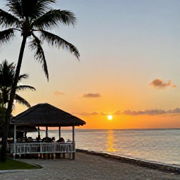 Caribbean Holidays, Cheap December Guadeloupe, Relaxed Guadeloupe sunset over a tropical beach with warm evening light, calm sea and a small seaside restaurant