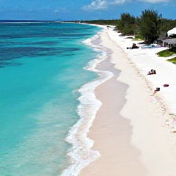 Caribbean Holidays, Cheap January Holidays, A bright aerial photograph of Grace Bay Beach in Turks and Caicos, with turquoise water, white sand and a few relaxed holidaymakers