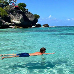 Caribbean Holidays, Cheap July Holidays, Snorkeller exploring clear Caribbean water near Saint Lucia, colourful fish and a rocky tropical coastline